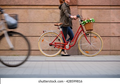 Woman Walking With Red Bike