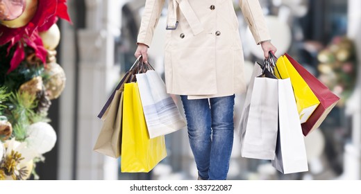 woman walking with shopping bags with christmas background. - Shutterstock ID 333722087