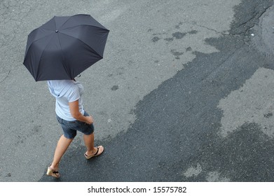 Woman Walking In Street With Umbrella.