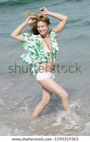 Woman walking in surf at beach