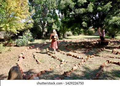 Woman Walking Through A Meditation Labyrinth