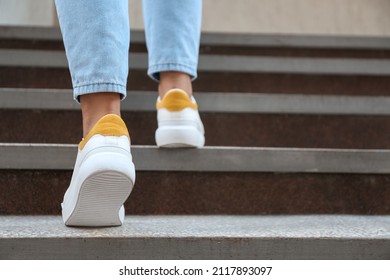 Woman walking upstairs outdoors, closeup - Shutterstock ID 2117893097
