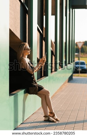 Similar – Woman with earphones listening music in smartphone