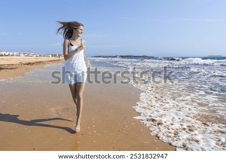 Similar – Young woman walks on the beach