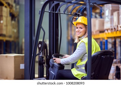 Woman warehouse worker with forklift. - Powered by Shutterstock