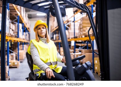 Woman Warehouse Worker With Forklift.