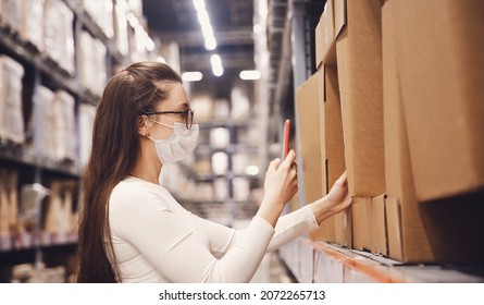 Woman Warehouse Worker In Protective Mask With Phone Scan Cardboard Box, Service Delivery.