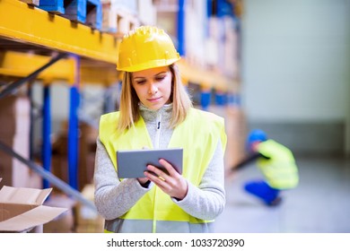 Woman Warehouse Worker With Tablet.