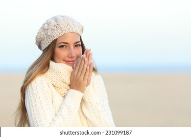 Woman Warmly Clothed In A Cold Winter On The Beach With The Sky In The Background