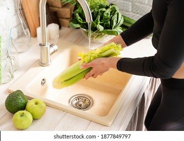 Woman Washing Celery in the Kitchen Sink - Powered by Shutterstock