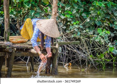 Woman Washing Clothes In The Mekong River