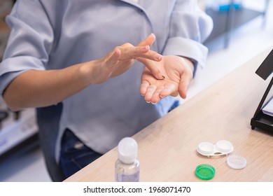 Woman washing contact lenses on her hand, cleaning contact lenses before putting them on, Health and eyes care concept