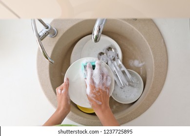 Woman Washing Dirty Dishes In Kitchen Sink, Top View. Cleaning Chores