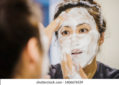 Woman Washing Face With Bubbles