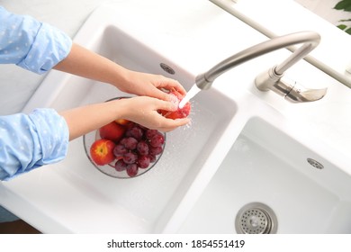 Woman Washing Fresh Nectarine In Kitchen Sink, Top View