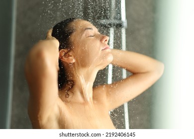 Woman Washing Hair Under Water Jet In A Shower