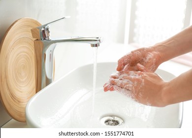 Woman washing hands indoors, closeup. Bathroom interior - Shutterstock ID 1551774701