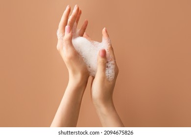 Woman washing hands with soap on color background - Shutterstock ID 2094675826