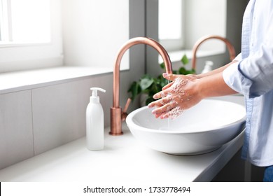 Woman washing hands under water tap. Self care and hygiene. Close up of female hand. Infection prevention. Liquid antibacterial soap and foam. Step by step instruction. Step 2.