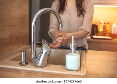 Woman Washing Her Hands. Hygiene concept. Washing hands with soap under the faucet with water. Woman washing hands indoors, closeup. Hygiene. Cleaning Hands.