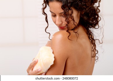 Woman Washing Her Skin With A Bath Sponge