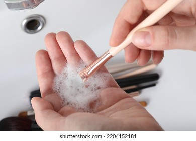 Woman Washing Makeup Brush With Soap, Closeup