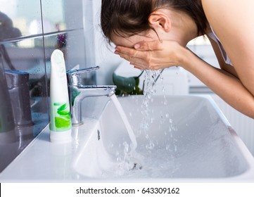 Woman washing up in the morning. Morning routine