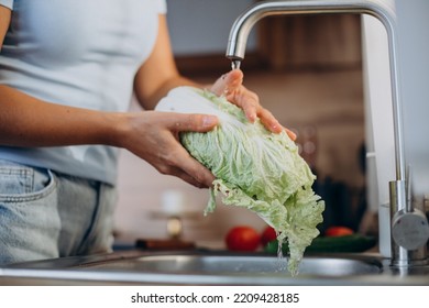 Woman Washing Salat At The Kitchen Sink