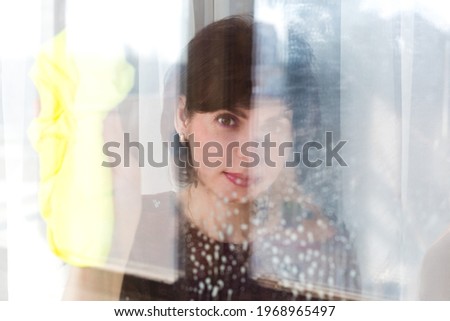 Hopeful Portrait of a Young Woman at the Window