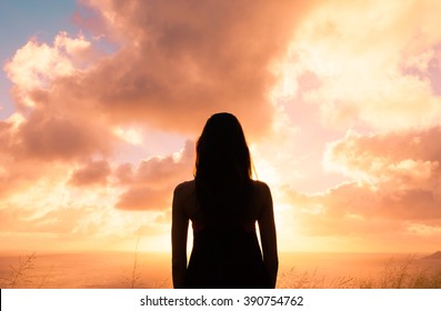 Woman Watching The Beautiful Sunset. 