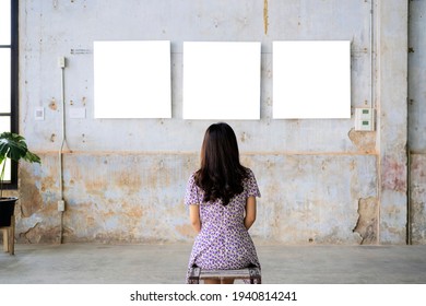 Woman Watching Blank Photo Frame On White Wall Art Gallery, Art Exhibition