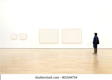 Woman Watching Blank Photo Frame On Wall Art Gallery, Art Exhibition 