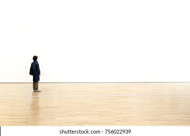 Woman watching  blank space wall in modern gallery, Art exhibition minimal concept