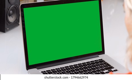 Woman Watching A Green Screen Laptop