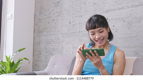 Woman Watching Movie On Mobile Phone At Home