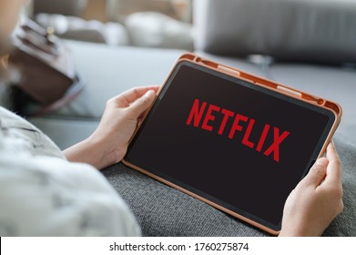 Woman Watching Netflix On IPad ,Netflix App On Tablet Screen. Netflix Is An International Leading Subscription Service For Watching TV Episodes And Movies : LOEI ,THAILAND,20 June 2020