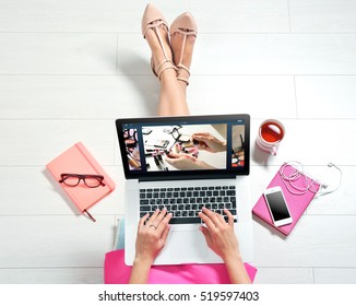 Woman watching online tutorial on laptop. Makeup and beauty blog.
