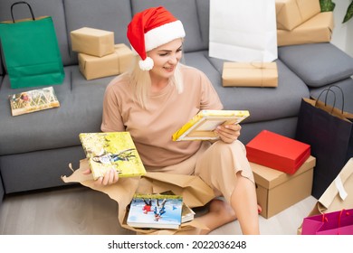 Woman Watching Photobook And Unpacking Gifts.