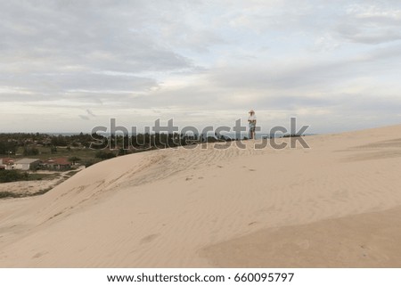 Woman watching sunset on the dunes.
North coastline, Rio Grande do Norte, Brazil.