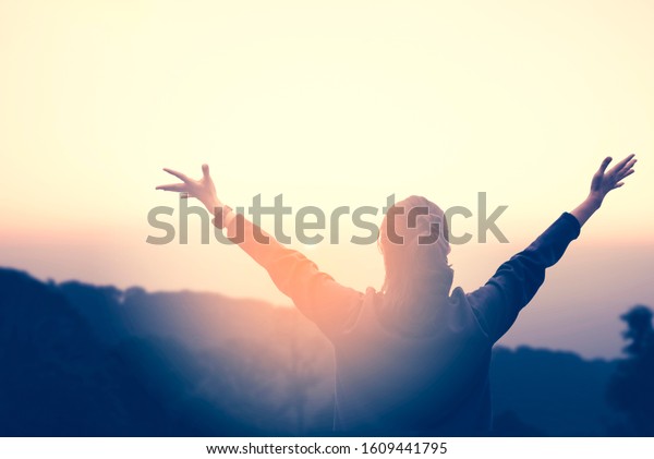 Woman Watching Sunset Raising Her Hands Stock Photo Edit Now