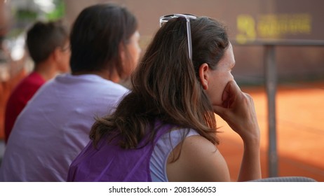 Woman watching tennis match. Spectators watching sport game.