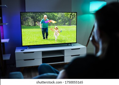 Woman Watching TV On Couch Or Sofa. Watch Television