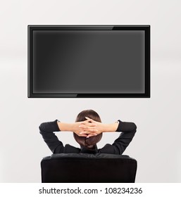 Woman Watching Tv. Photo From Behind. Editable Copyspace At The Screen