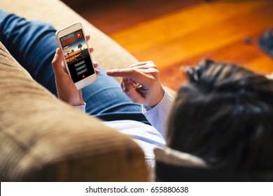 Woman Watching Tv Series In A Mobile Phone App, While Rest At Home.