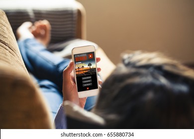 Woman Watching Tv Series In A Mobile Phone App, While Rest At Home.