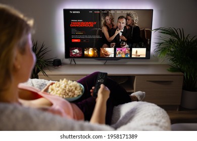 Woman watching TV series and movies via streaming service at home