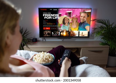 Woman watching TV series and movies on online streaming service at home