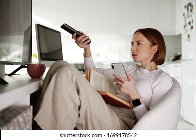 Woman Watching Tv, Using Remote Control And Phone, Channel Surfing, Getting Information And Latest News, Watching Movies, Bored At Home. Reading Book. Weekend And Free Time, Social Media And Network