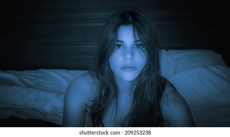 Woman Watching Tv Or Viewing Laptop Computer In The Dark With Blue Light Glowing On Her Face 