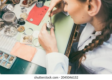 Woman Watchmaker Working Diligently On Repairing A Watch